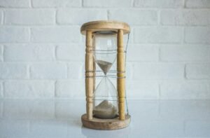 A wood hourglass losing time. Photo by Kenny Eliason on Unsplash