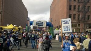 Volunteers supporting a food drive in partnership with the Seattle football team